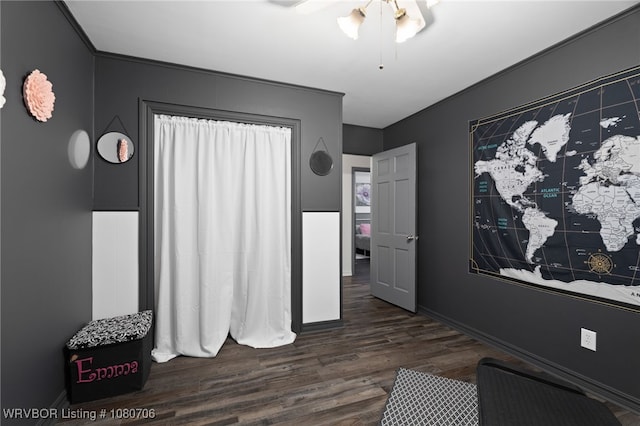 interior space featuring baseboards and wood finished floors
