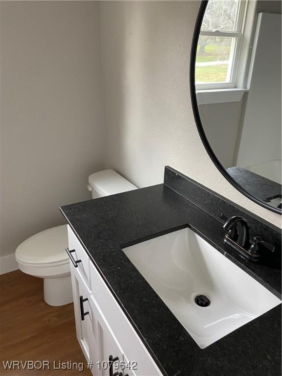 518 N Coker St Unit A & B, Greenwood, AR 72936 - bathroom with vanity, toilet, wood finished floors, and baseboards