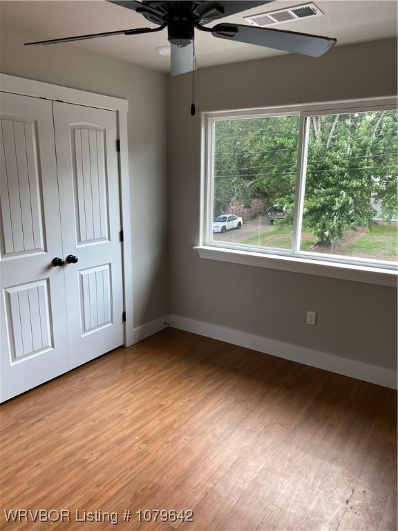 518 N Coker St Unit A & B, Greenwood, AR 72936 - unfurnished bedroom with a ceiling fan, visible vents, baseboards, a closet, and light wood-type flooring