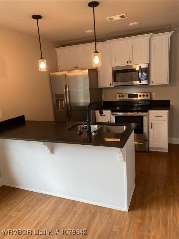 518 N Coker St Unit A & B, Greenwood, AR 72936 - kitchen featuring visible vents, a sink, dark countertops, appliances with stainless steel finishes, and white cabinets