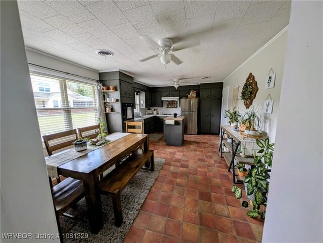 1385 Old Airport Rd, Paris, AR 72855 - dining space with ornamental molding, ceiling fan, and dark tile patterned flooring