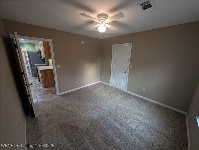 1385 Old Airport Rd, Paris, AR 72855 - empty room with ceiling fan, baseboards, and light colored carpet