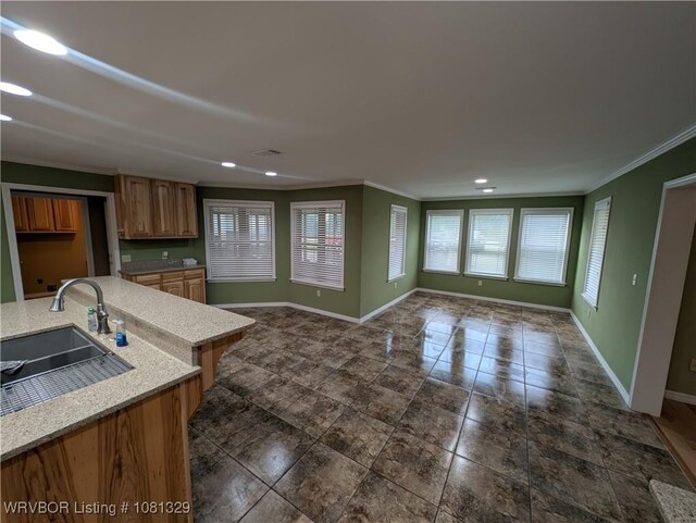 1385 Old Airport Rd, Paris, AR 72855 - kitchen featuring a sink, ornamental molding, baseboards, open floor plan, and recessed lighting
