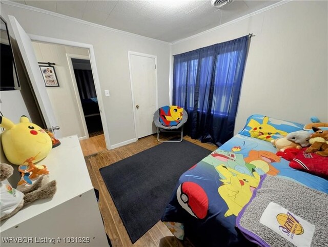 1385 Old Airport Rd, Paris, AR 72855 - bedroom featuring wood finished floors and ornamental molding