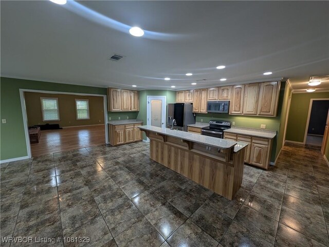 1385 Old Airport Rd, Paris, AR 72855 - kitchen with black appliances, baseboards, light countertops, recessed lighting, and a kitchen island with sink