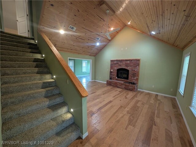 1385 Old Airport Rd, Paris, AR 72855 - unfurnished living room featuring wooden ceiling, vaulted ceiling, wood finished floors, stairs, and baseboards
