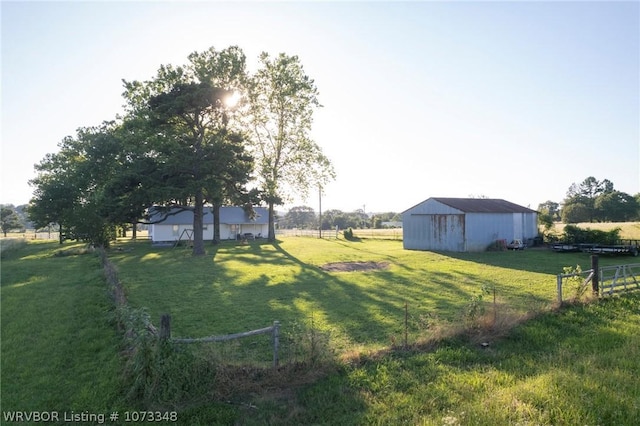 view of yard with a rural view and an outdoor structure