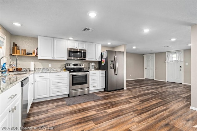 kitchen featuring white cabinets, dark hardwood / wood-style flooring, sink, and stainless steel appliances