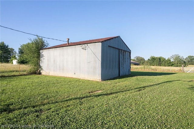 view of outdoor structure with a yard and a rural view