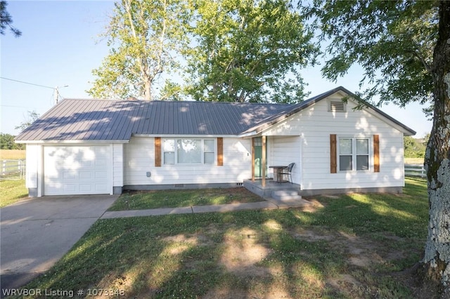 ranch-style home featuring a garage and a front yard