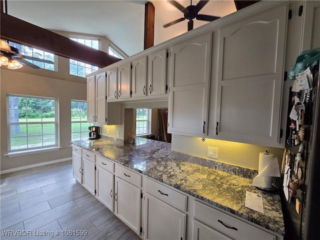 20222 Garman Rd, Gentry, AR 72734 - kitchen featuring ceiling fan, white cabinetry, stone counters, and high vaulted ceiling