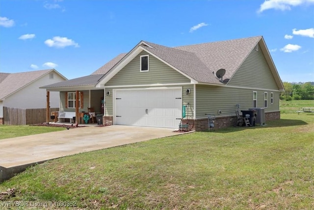 craftsman house with a garage, driveway, a front lawn, and fence