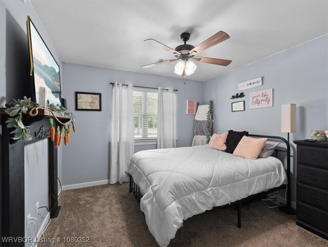 carpeted bedroom with ceiling fan and baseboards