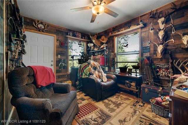 175 Sulphur City Rd, Fayetteville, AR 72701 - living area featuring a ceiling fan, a textured ceiling, and wood walls