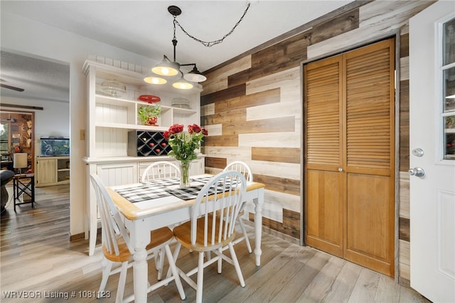 175 Sulphur City Rd, Fayetteville, AR 72701 - dining room with wood walls and light wood-style floors