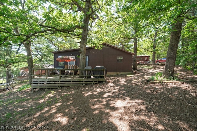 175 Sulphur City Rd, Fayetteville, AR 72701 - back of house with a deck and a trampoline