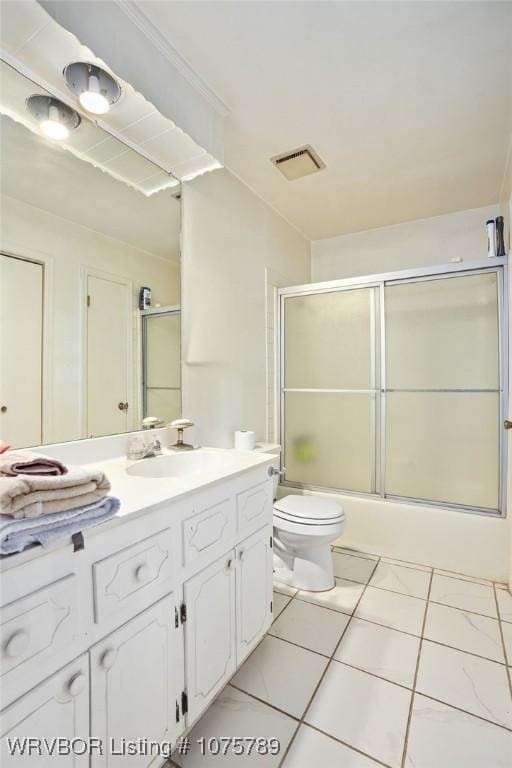 full bathroom featuring combined bath / shower with glass door, vanity, toilet, and tile patterned flooring