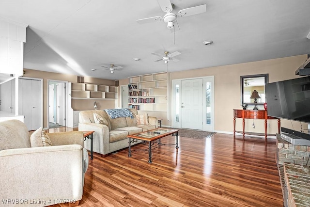 living room with ceiling fan, built in features, and hardwood / wood-style floors