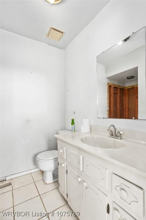 bathroom featuring tile patterned floors, toilet, and vanity