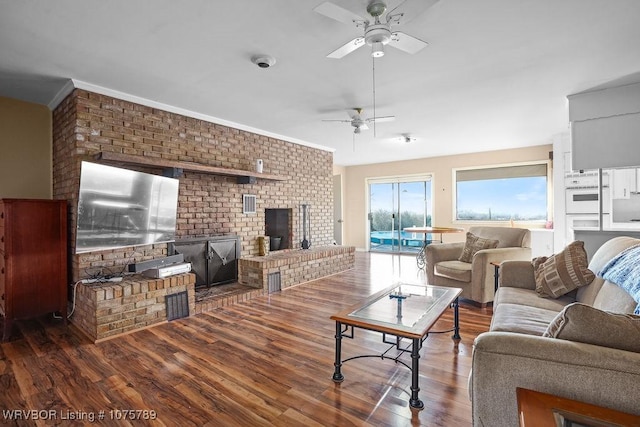 living room with ceiling fan, dark hardwood / wood-style flooring, and a fireplace