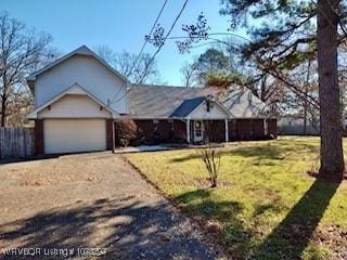 view of front of property featuring a garage and a front lawn