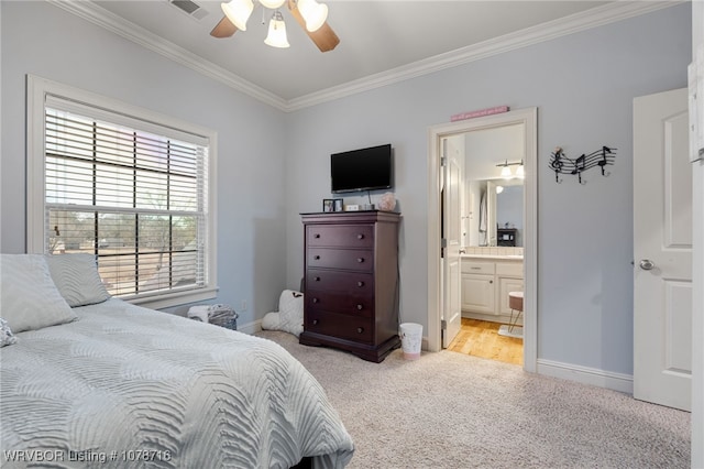 bedroom with light carpet, crown molding, ceiling fan, and ensuite bathroom