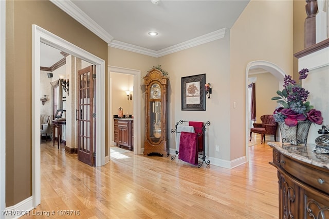 hallway featuring crown molding and light hardwood / wood-style floors