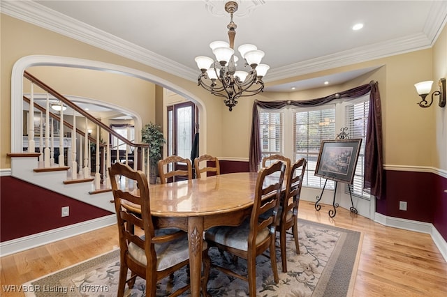 dining space featuring a notable chandelier, a wealth of natural light, and light hardwood / wood-style floors