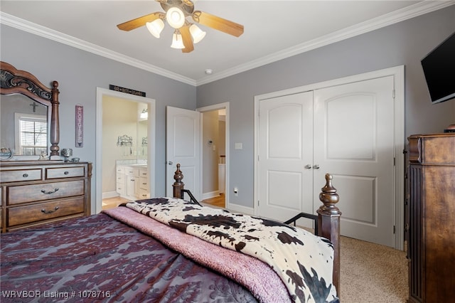 carpeted bedroom featuring ceiling fan, ornamental molding, ensuite bathroom, and a closet