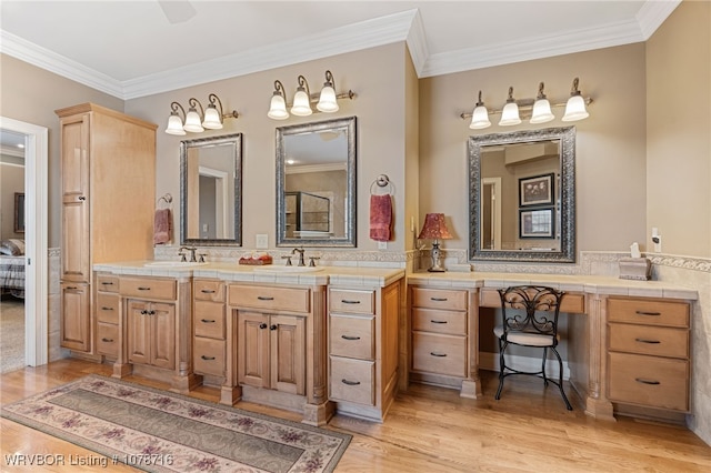 bathroom featuring hardwood / wood-style flooring, vanity, and crown molding