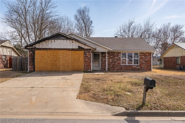 single story home with brick siding, a shingled roof, central AC unit, driveway, and an attached garage