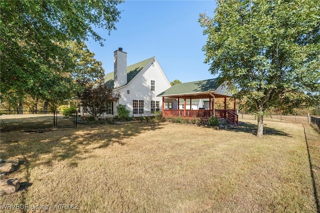 back of house with a lawn