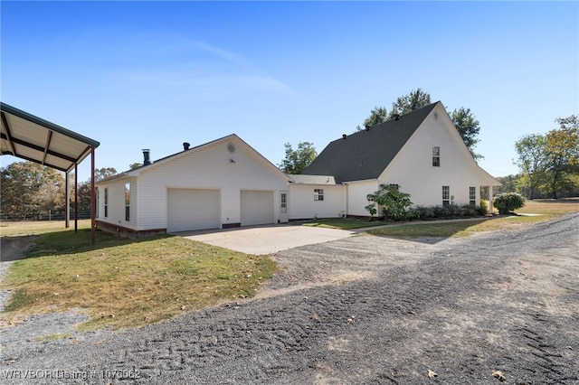 view of property exterior with a garage and a lawn