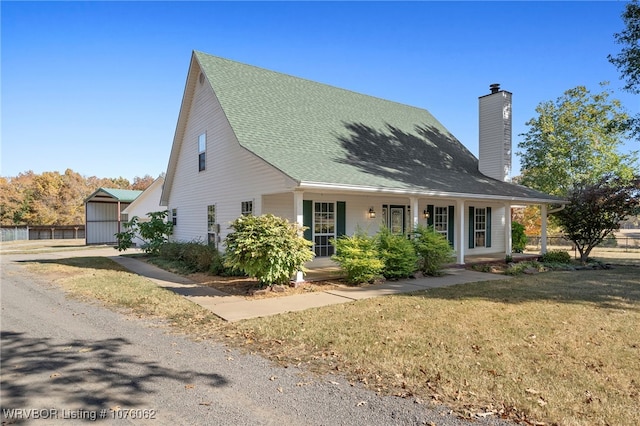 view of front facade with a front yard and a porch