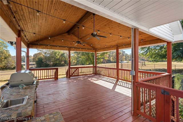 wooden terrace with a grill, ceiling fan, and sink