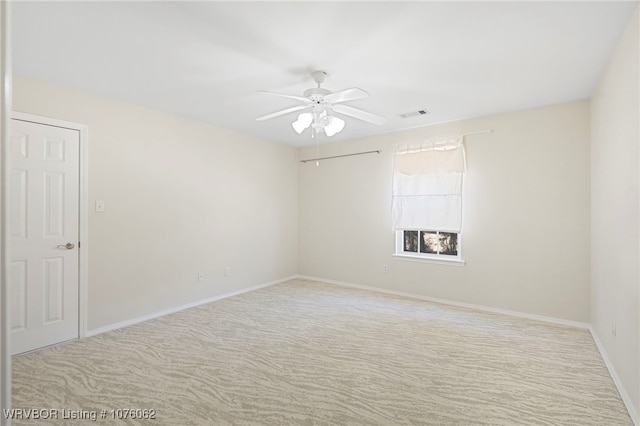 empty room with light colored carpet and ceiling fan