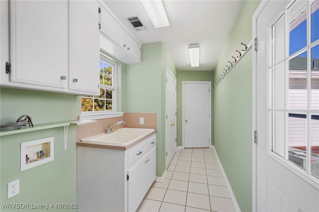 interior space featuring white cabinetry, sink, and light tile patterned floors