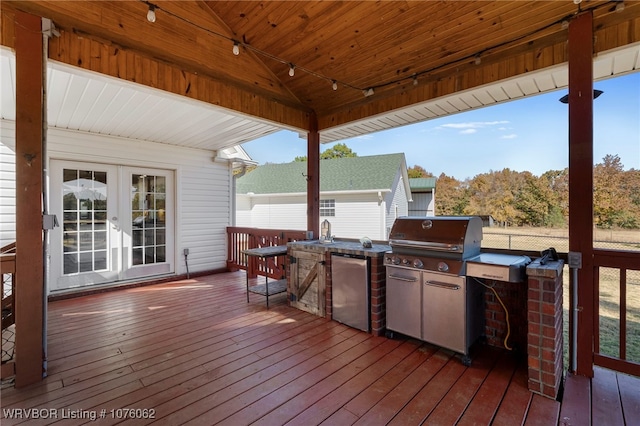 wooden deck with area for grilling and french doors