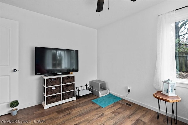 living area with dark hardwood / wood-style floors and ceiling fan