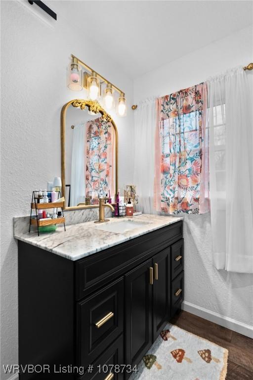 bathroom with vanity and wood-type flooring