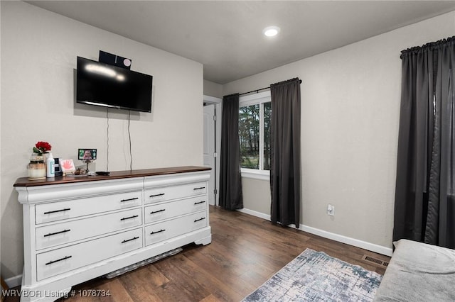 bedroom with dark hardwood / wood-style floors