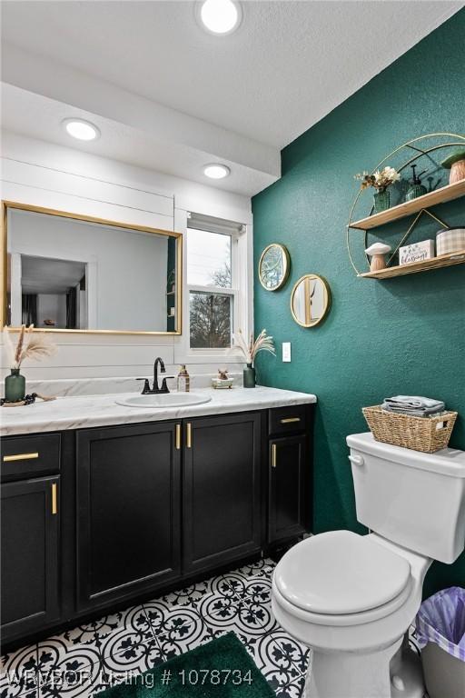 bathroom with vanity, toilet, and tile patterned floors