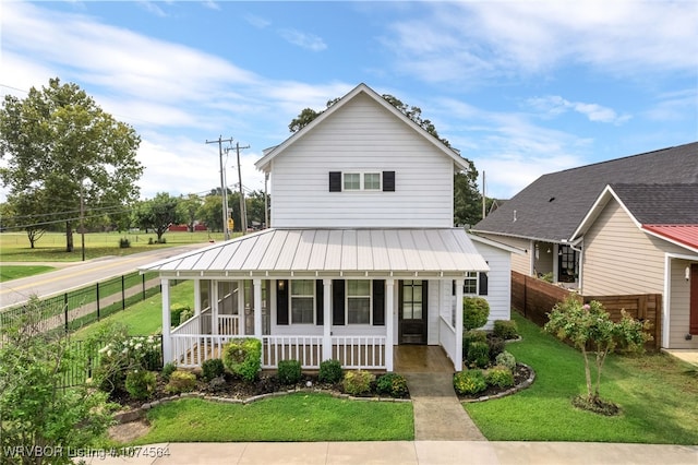 view of front of home featuring covered porch and a front yard