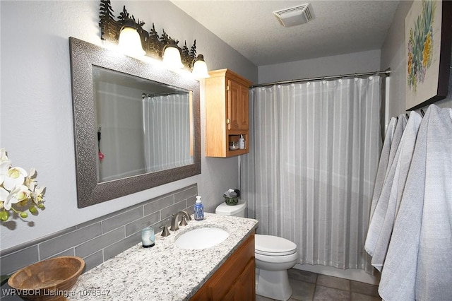 bathroom with backsplash, vanity, a textured ceiling, toilet, and walk in shower