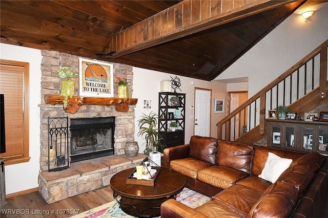 living room with hardwood / wood-style flooring, vaulted ceiling, wooden ceiling, and a fireplace