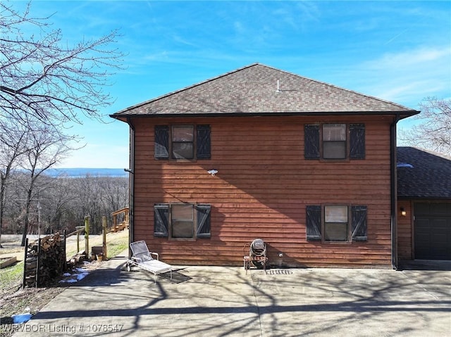 back of house with a garage