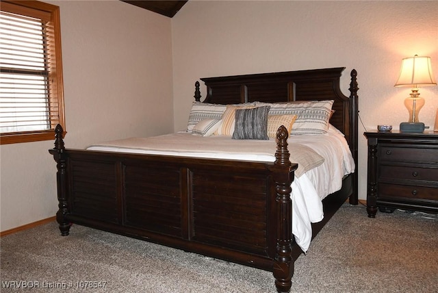 bedroom with multiple windows, lofted ceiling, and carpet