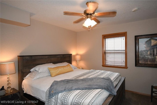 carpeted bedroom with a textured ceiling and ceiling fan