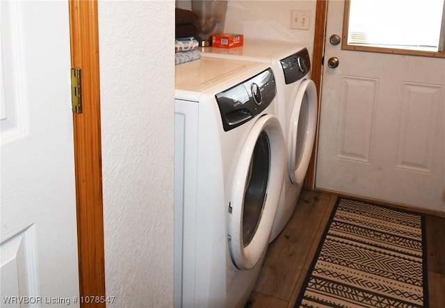 laundry area featuring separate washer and dryer and wood-type flooring