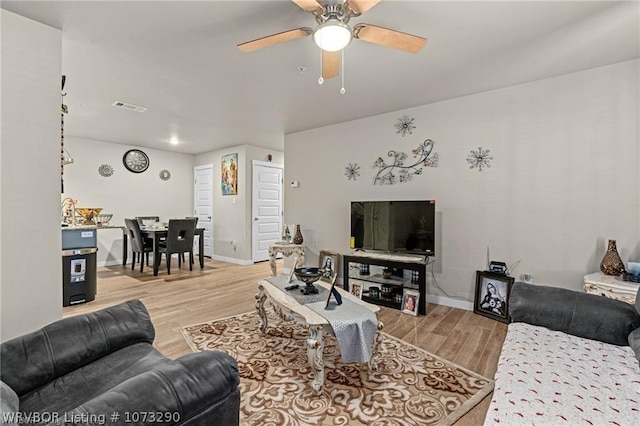 living room with ceiling fan and light hardwood / wood-style floors